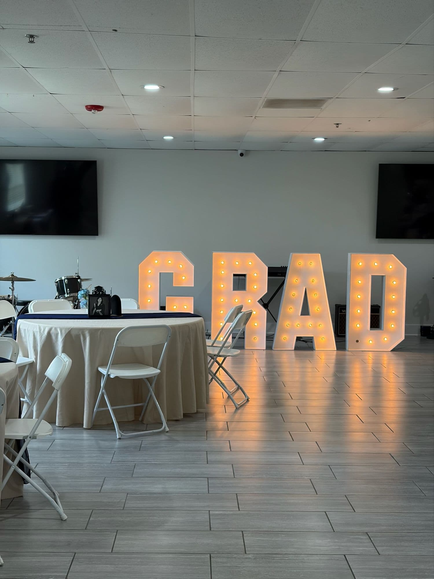 Marquee GRAD letters lighting up the room