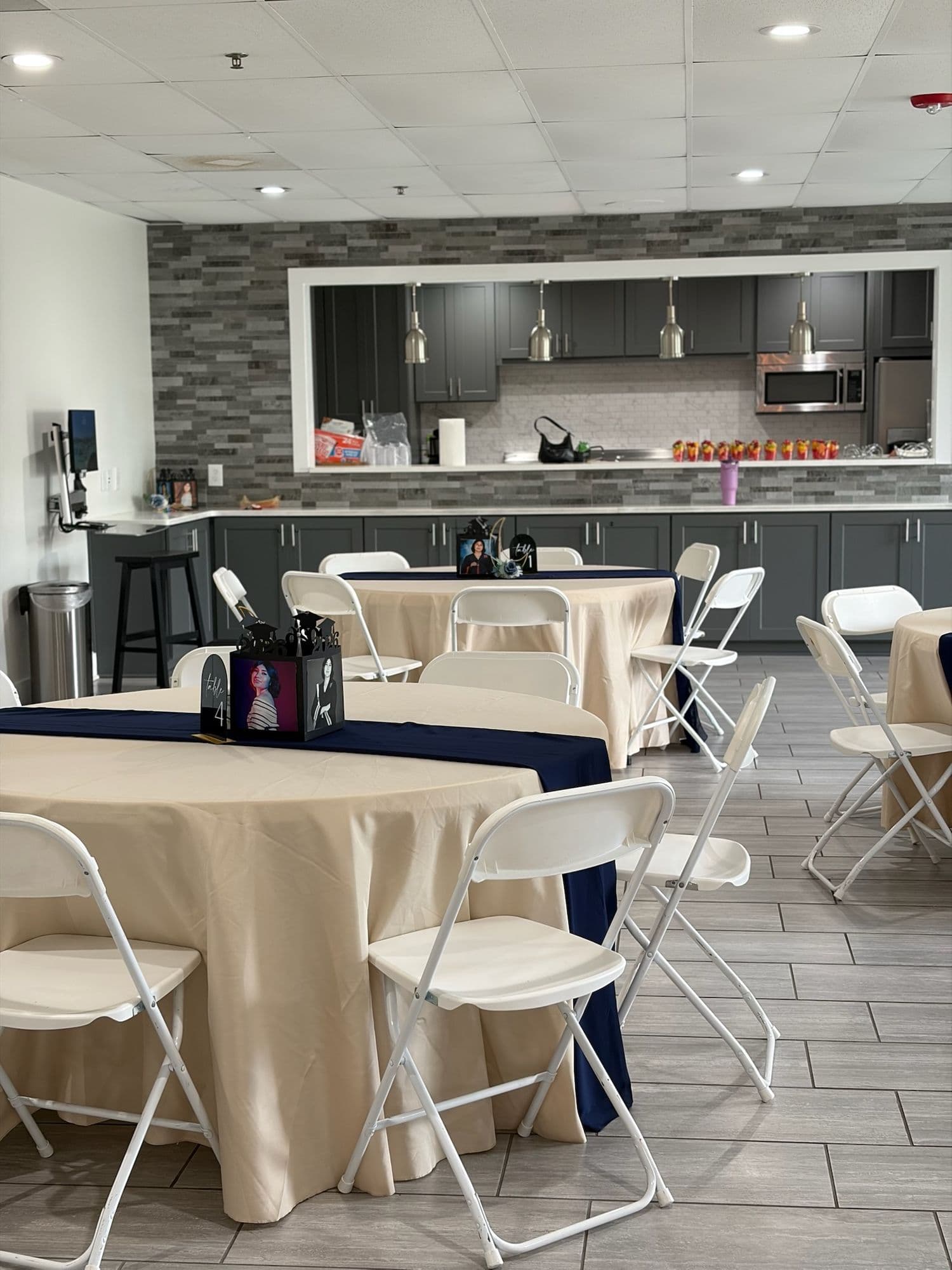 Guest tables with navy runners and champagne linens