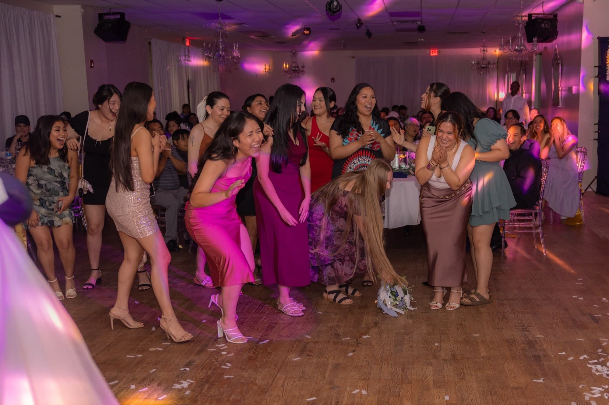 Guests gathered on the dance floor for the bouquet toss