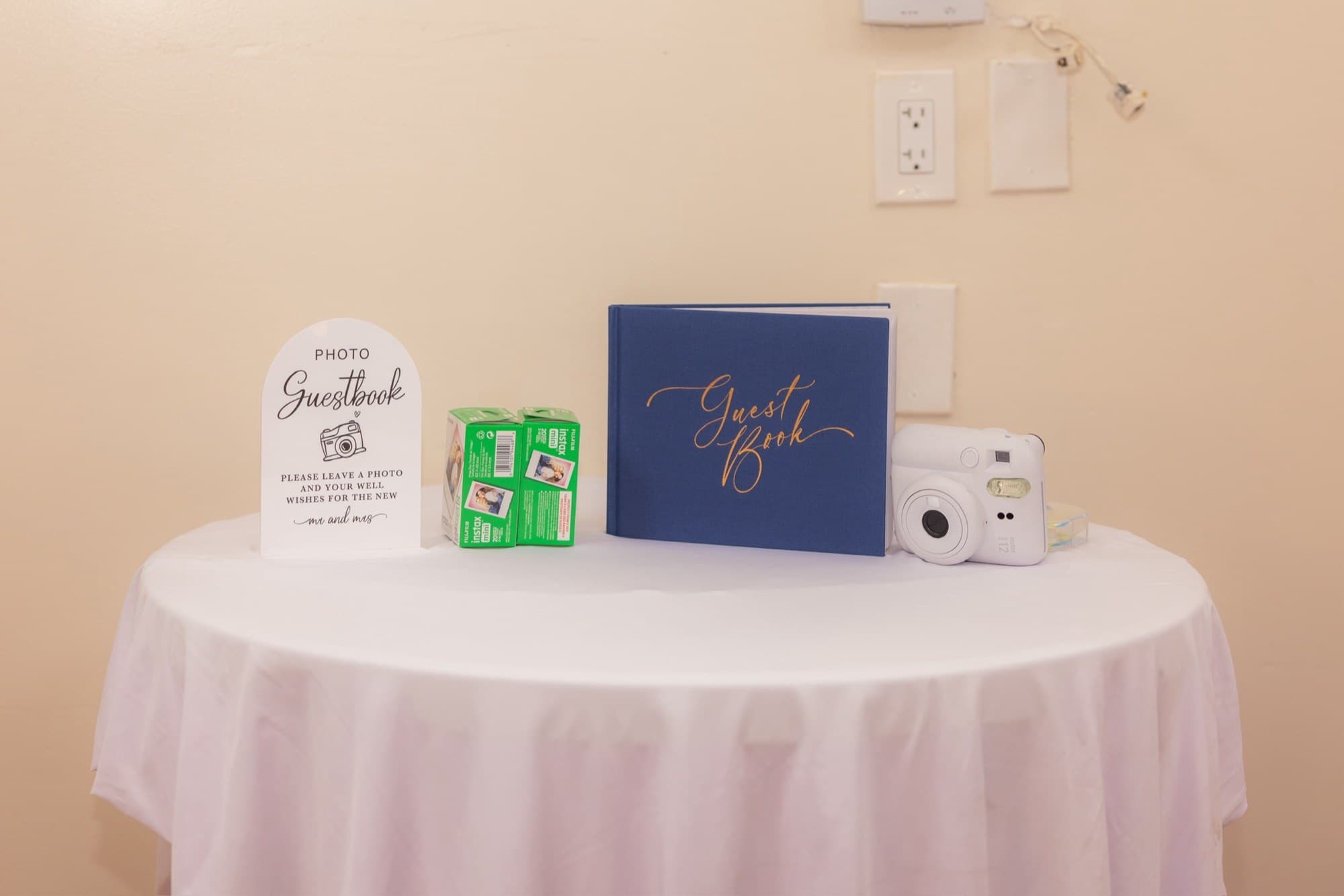 Navy photo guestbook with an instant camera and film