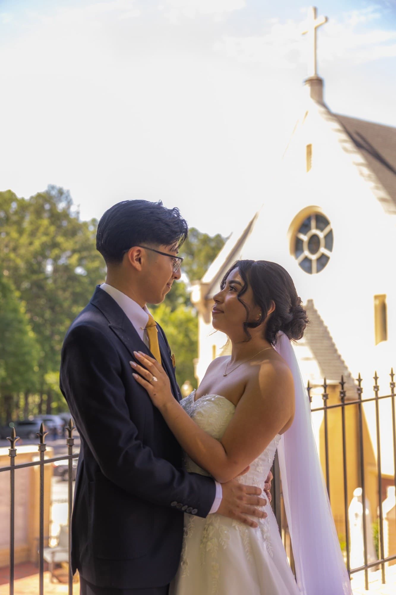 Bride and groom embracing outside the church after the ceremony