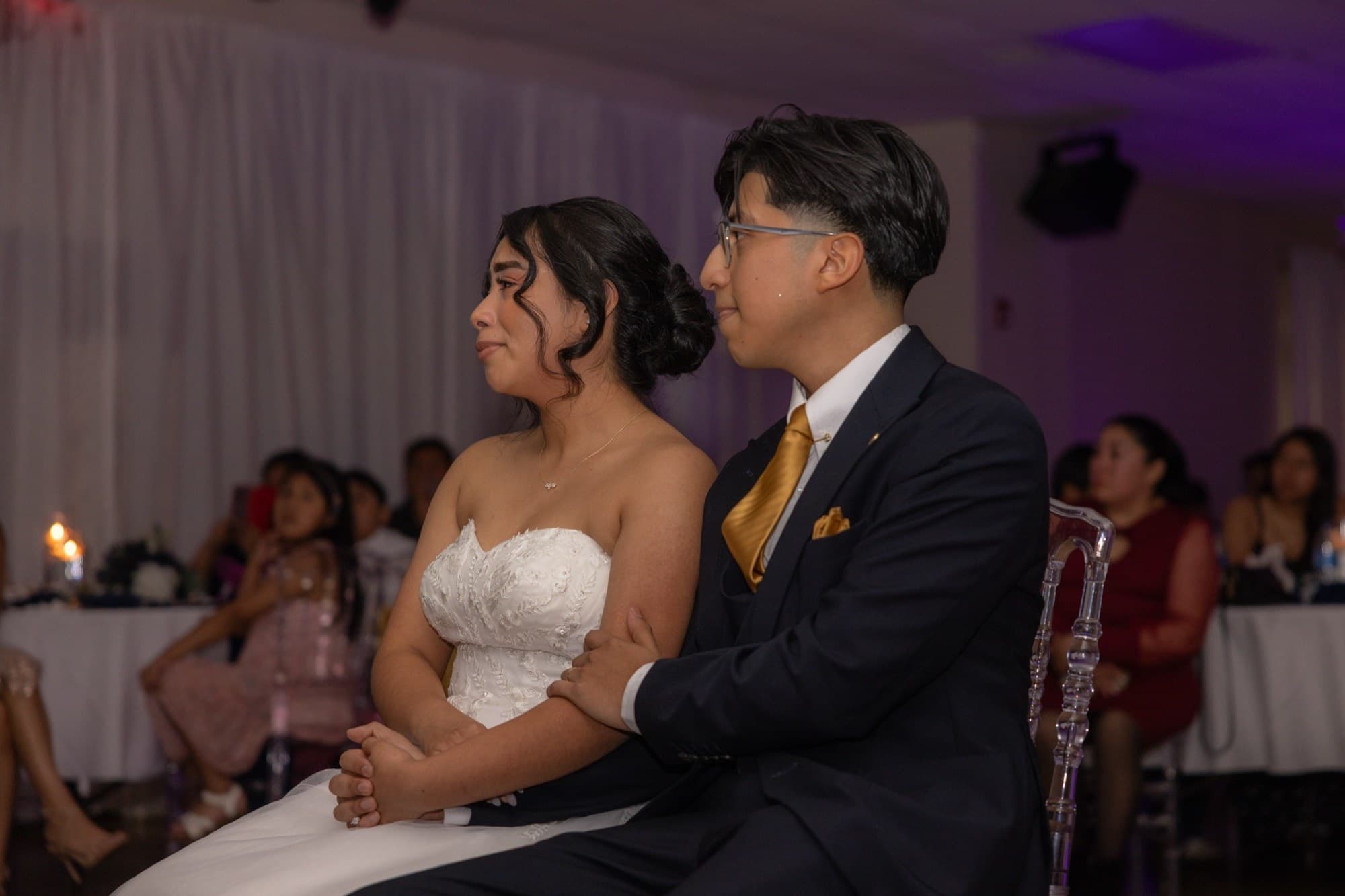 The newlyweds seated together during the reception