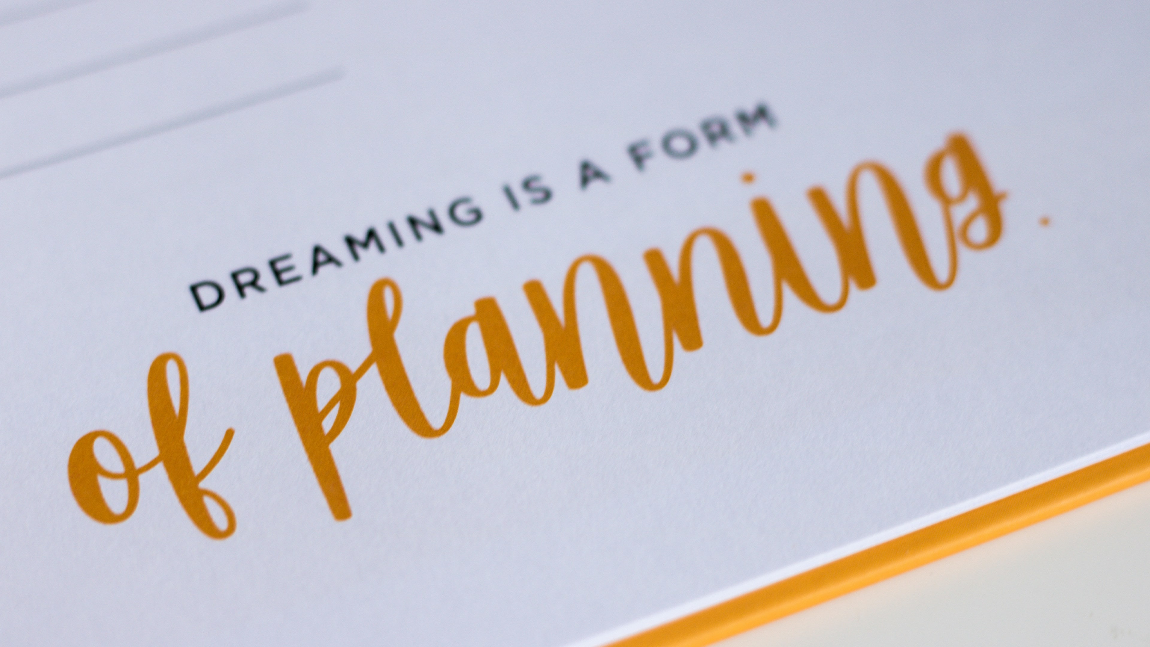 Hand-lettered stationery that reads “dreaming is a form of planning”
